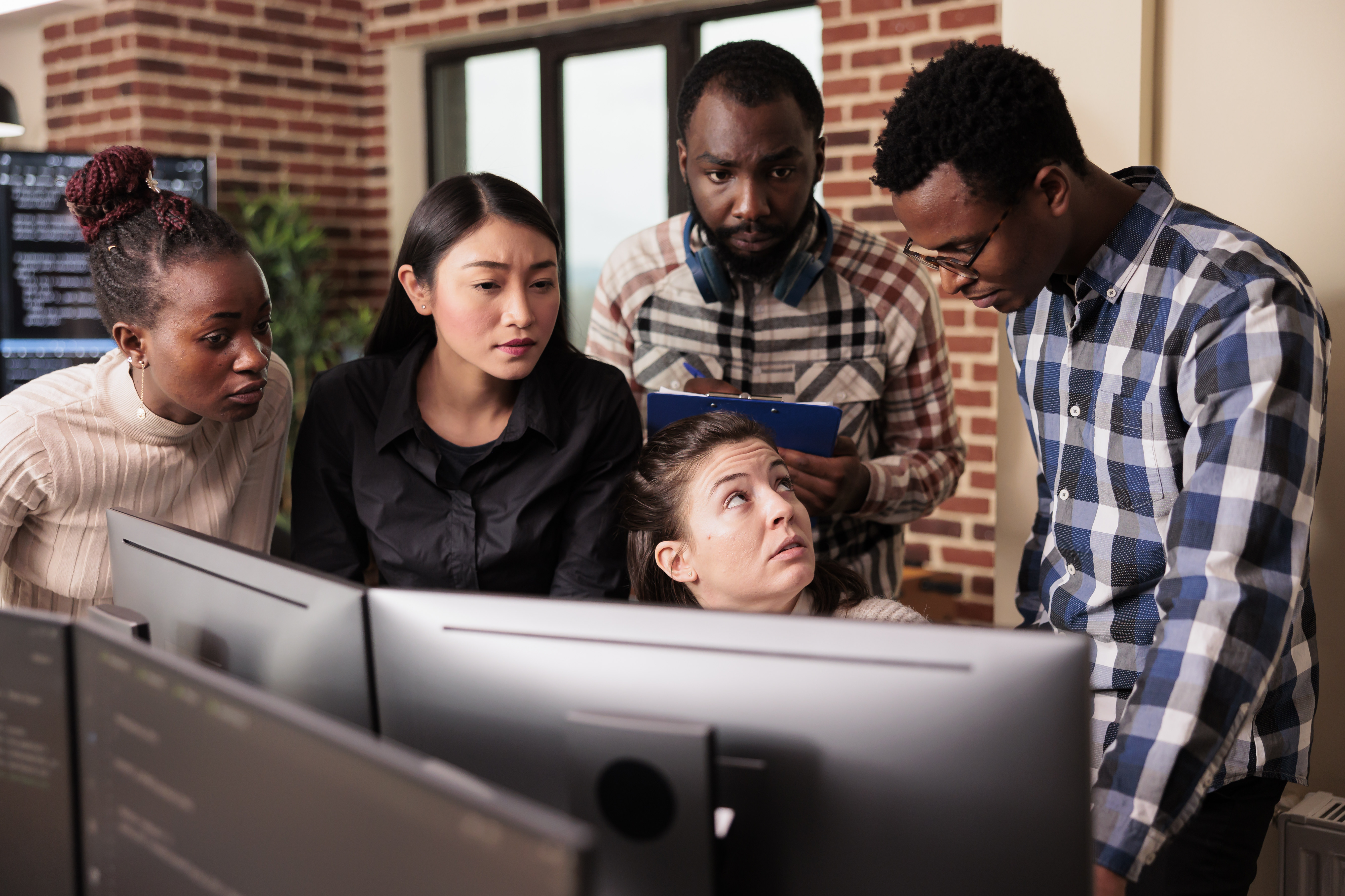 Customer support team working at desks with headsets